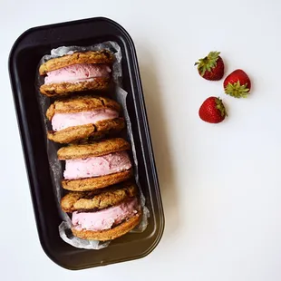 Ice cream sandwiches made with Chocolate Chunks cookies &amp; Strawberry Cheesecake Ice Cream
