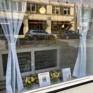 a window display with yellow flowers