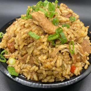 a plate of rice with meat and vegetables