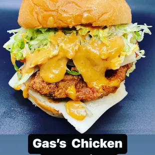 a chicken sandwich with cheese and lettuce