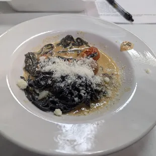 Squid ink taglione with lobster and tomatoes