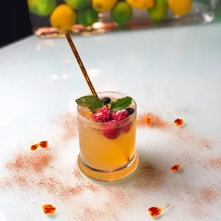 Apple Cider Vodka Cocktail with frozen berries and mint dusted with Vietnamese Cinnamon