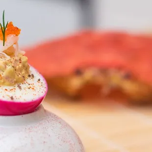 Beet Pickled Deviled Eggs, Infused with Alaskan Dungeness Crab, Topped with Flying Fish Caviar.