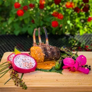 Grilled Te Mana Lamb, drizzled with a smoked chipotle coconut sauce and sauteed shishito peppers