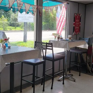 a table and chairs in front of a window