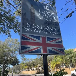 a sign for a restaurant on a street corner