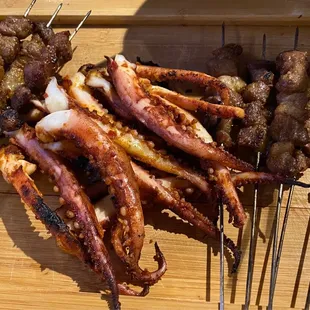 a variety of meats on skewers