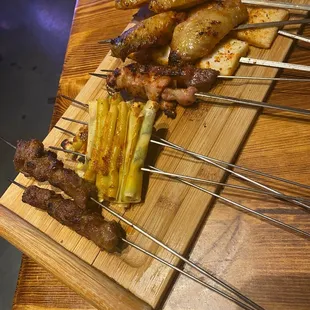 Left to right lamb, tofu cilantro roll, chicken, beef, fish tofu, chicken wing skewer.