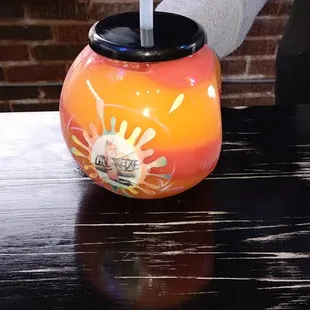 a person holding a straw in a vase