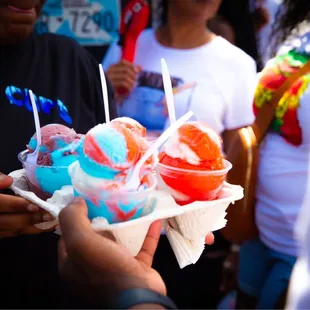 a person holding a tray of ice cream