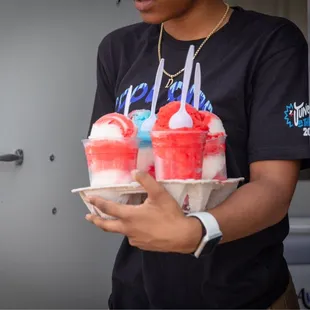 a man holding a tray of ice cream