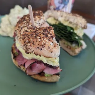 Ironman and destroyer bagel sandwich with side of potato salad.