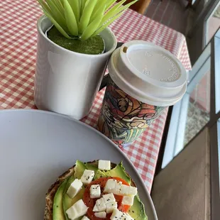 an avocado sandwich and a cup of coffee
