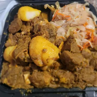 Curry Goat with cabbage and rice and peas. It was so flavorful! Best I've had in Charles County!