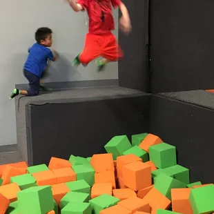 Small children area with their own foam pit, trampolines and play structure