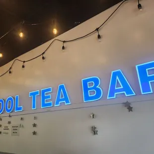 a neon sign on the wall