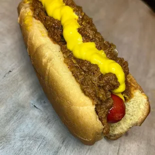 a chili dog with mustard