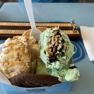 three scoops of ice cream in a paper container