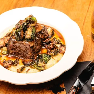 Braised Short Rib w/cheddar polenta, crispy brussels sprouts,natural jus