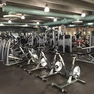 Many machines, free weights, and dumbbells for strength training.