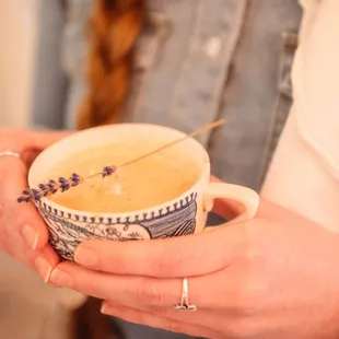a woman holding a cup of coffee