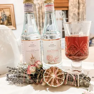 two bottles of gin and a glass of gin