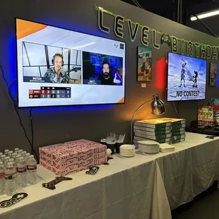 Tables were set up for water, fountain drink station was to the left, and pizza.