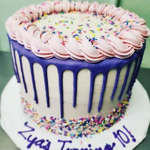 a cake with icing and sprinkles