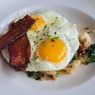 Breakfast carbonara gnocchi with sausage,  spinach,  bacon,  egg