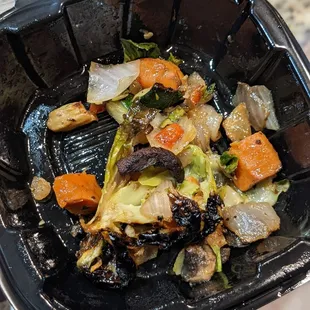  a close up of a black container of food