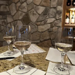  three glasses of wine on a table