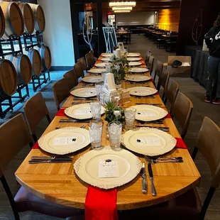  a long table set with wine barrels