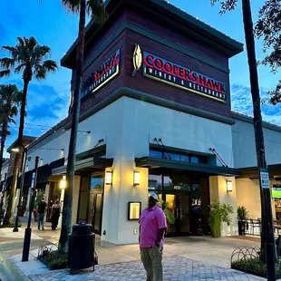 a man walking in front of the restaurant