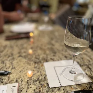 a glass of wine on the bar