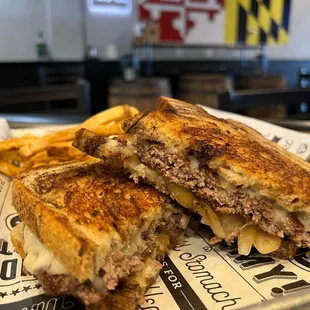 a grilled cheeseburger and french fries