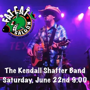 a man in a cowboy hat playing a guitar