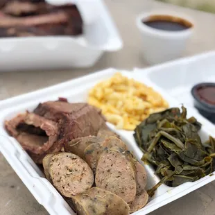 Brisket and Homemade Texas Sausage with Mac &amp; Cheese and Collard Greens on the side.