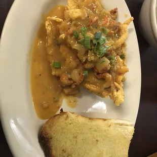 Fried catfish with shrimp etouffee on top.