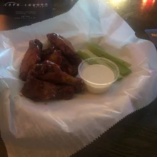 chicken wings and celery in a basket