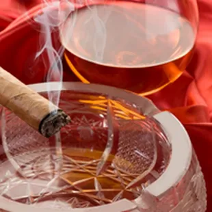 a glass of alcohol and a cigar