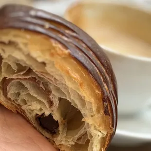 a hand holding a half eaten pastry