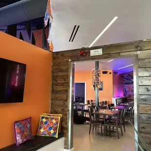 a dining room with orange walls