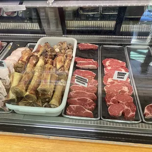 Meat counter. Bones, rib eyes, other beef cuts.
