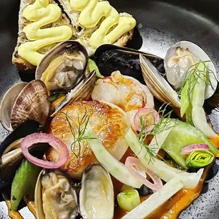 BOUILLABAISSE mussels, manila clams, pacific shrimp, scallop, tomato, grilled bread, saffron rouille