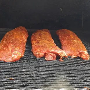 the meat being cooked on the grill