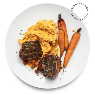 a plate of food with carrots and meat