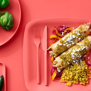 a plate of food on a pink background