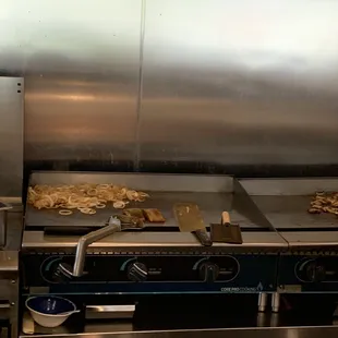 a commercial kitchen with a lot of food on the counter