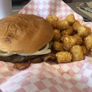 Bacon Cheeseburger with mustard, pickles, and onions along with and a side of tots.