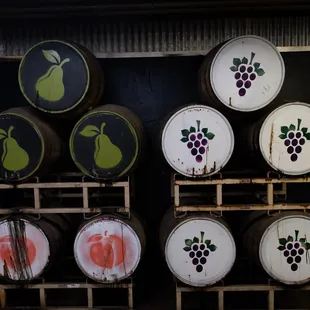 stacked barrels with grapes on them